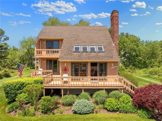 back of house featuring a balcony and a deck