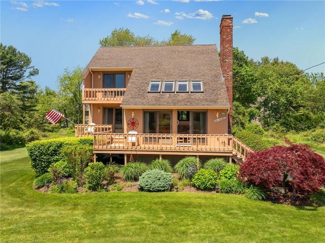 back of house with a lawn and a deck