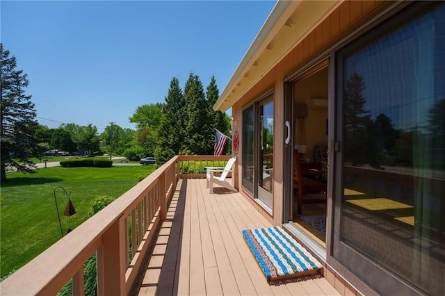 wooden terrace featuring a lawn