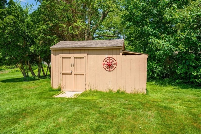 view of outbuilding with a lawn