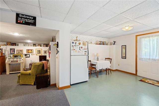 kitchen featuring a paneled ceiling and white fridge