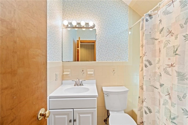 bathroom with vanity, toilet, tile walls, and a shower with shower curtain