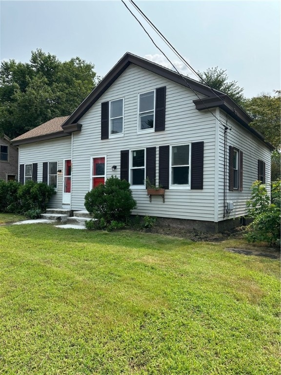 back of property featuring a yard