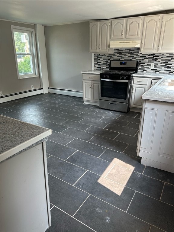 kitchen featuring stainless steel gas stove, a baseboard heating unit, and tasteful backsplash