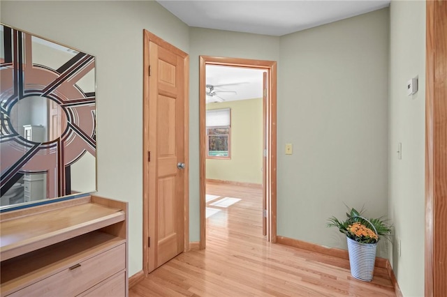 corridor with light hardwood / wood-style floors