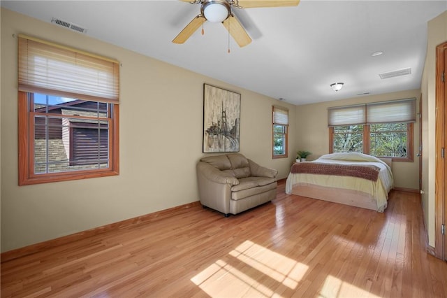 bedroom with light hardwood / wood-style floors and ceiling fan