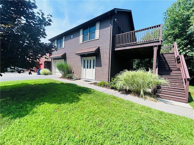 view of property exterior featuring a lawn, a garage, and a wooden deck