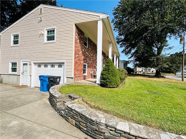 view of home's exterior with a garage and a yard