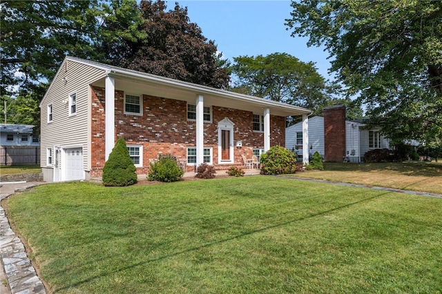 bi-level home with a garage and a front yard