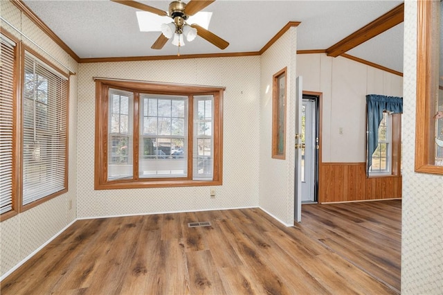 interior space featuring vaulted ceiling with beams, crown molding, hardwood / wood-style floors, and ceiling fan