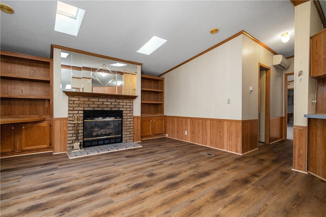 unfurnished living room with a brick fireplace, a textured ceiling, a wall unit AC, and dark wood-type flooring