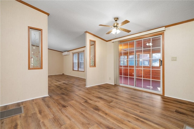 unfurnished room featuring hardwood / wood-style floors, a textured ceiling, ceiling fan, and ornamental molding