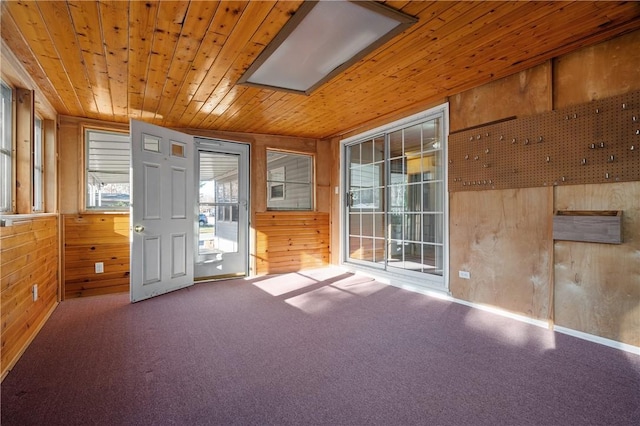 interior space featuring lofted ceiling, wooden ceiling, and wooden walls