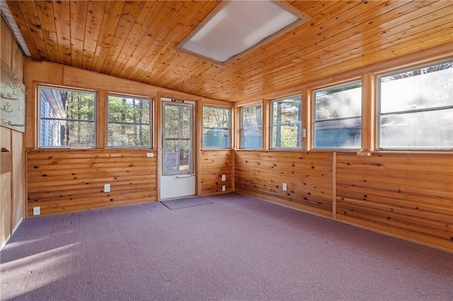 unfurnished sunroom featuring a healthy amount of sunlight, wooden ceiling, and vaulted ceiling