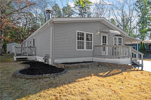 view of front of home featuring a shed and a front lawn