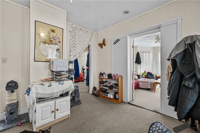 miscellaneous room with light colored carpet and ceiling fan