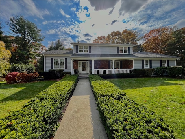 view of front of property with a front yard and a porch