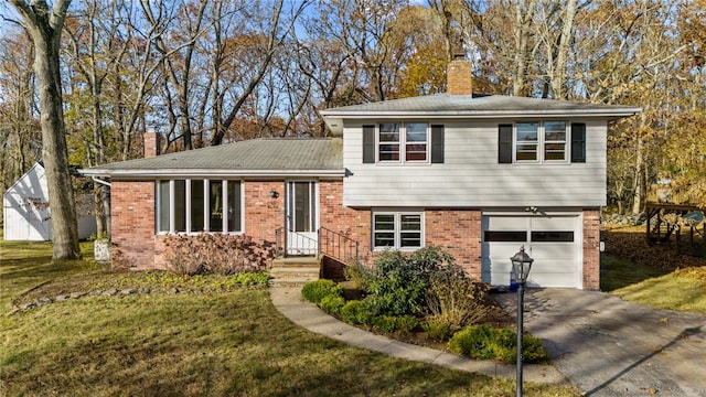 tri-level home with a front yard and a garage