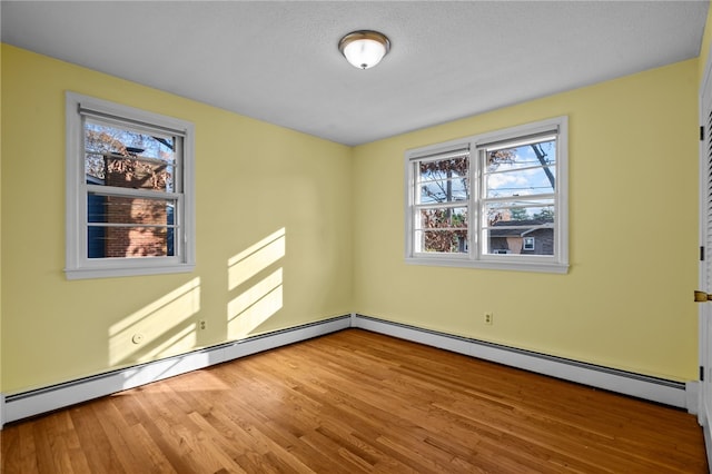 unfurnished room with a textured ceiling and hardwood / wood-style flooring