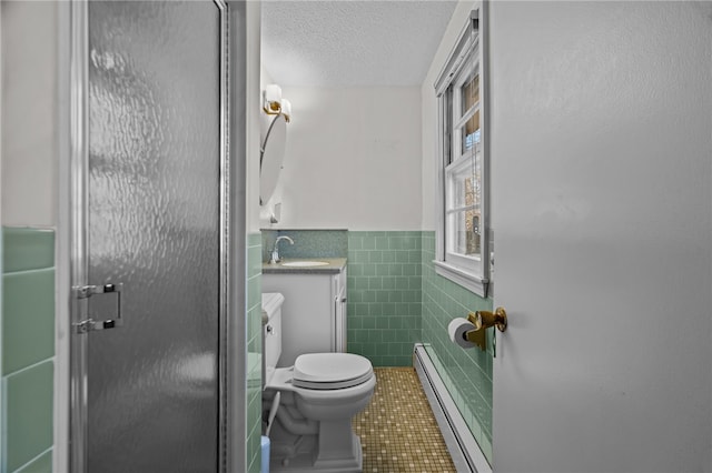 bathroom featuring vanity, tile patterned floors, toilet, tile walls, and a baseboard radiator