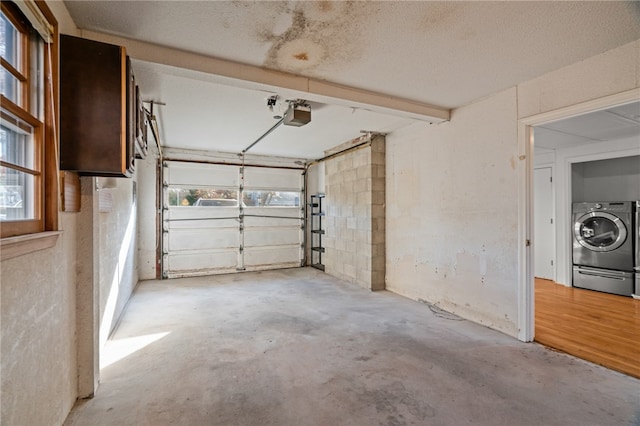 garage featuring washer / dryer and a garage door opener