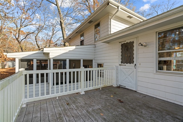 wooden deck with a sunroom