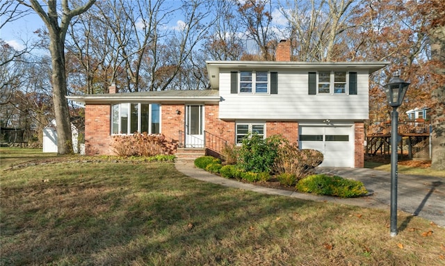 split level home with a front yard and a garage