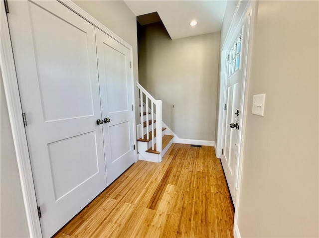 unfurnished bedroom featuring ceiling fan, a closet, and light hardwood / wood-style flooring