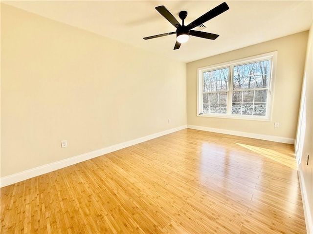 empty room with ceiling fan and light hardwood / wood-style floors