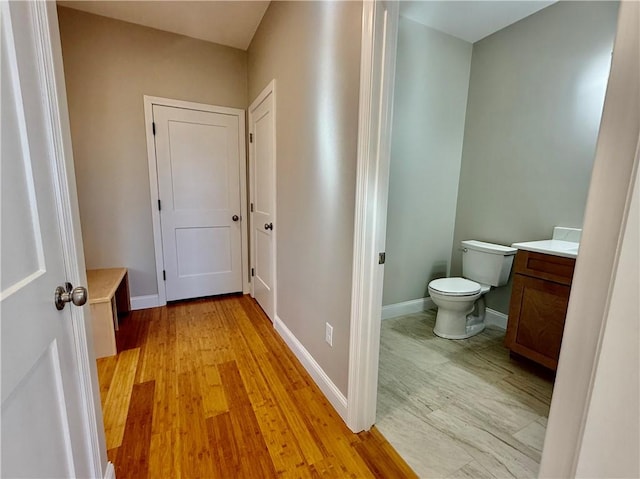 bathroom with vanity, hardwood / wood-style floors, and toilet