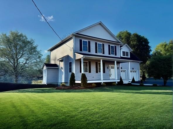 view of front of house featuring covered porch and a front lawn