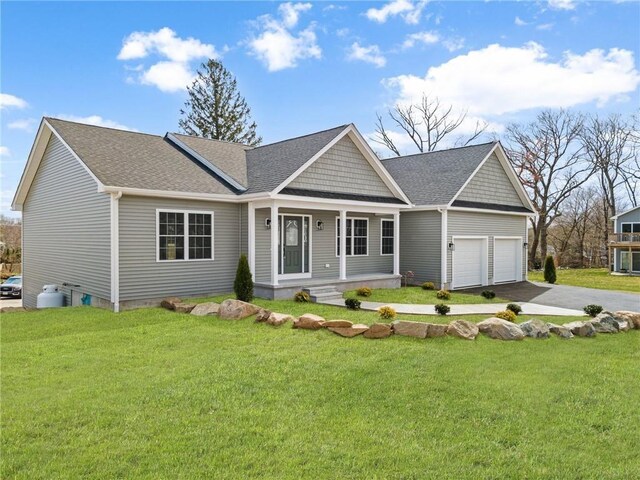 view of front of property with a garage and a front lawn