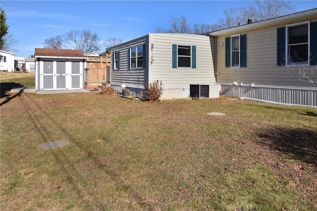 back of property featuring a lawn and a storage unit