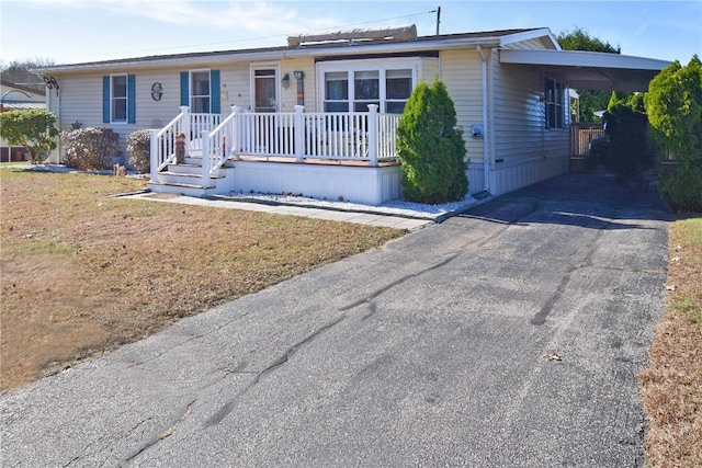 single story home with a front yard and a carport