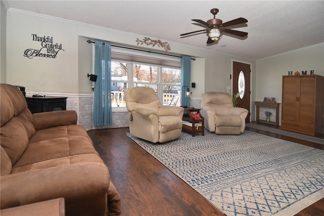 living room featuring a textured ceiling, dark hardwood / wood-style flooring, ceiling fan, and crown molding