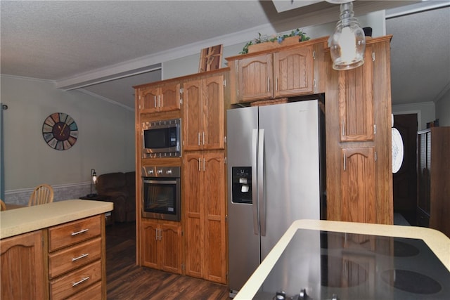 kitchen featuring crown molding, vaulted ceiling with beams, dark hardwood / wood-style floors, a textured ceiling, and appliances with stainless steel finishes