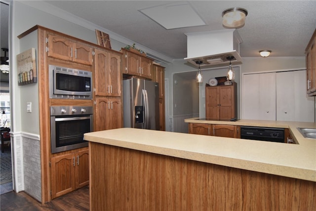 kitchen featuring crown molding, hanging light fixtures, dark hardwood / wood-style floors, kitchen peninsula, and stainless steel appliances