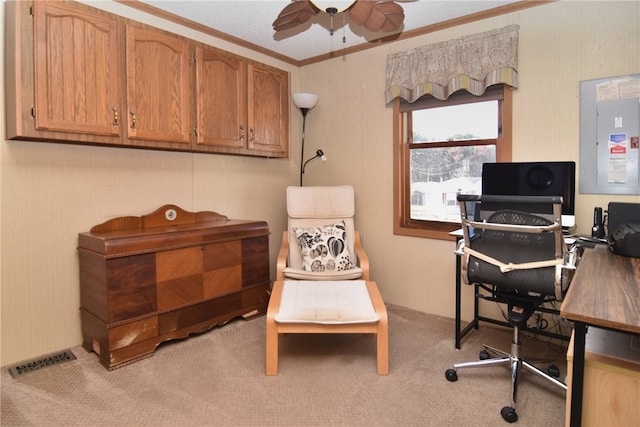 office area featuring ceiling fan, light colored carpet, crown molding, and electric panel