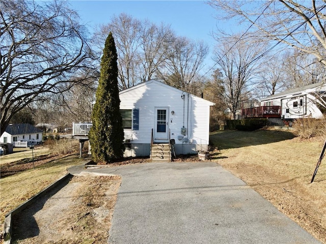 exterior space featuring a deck and a front lawn