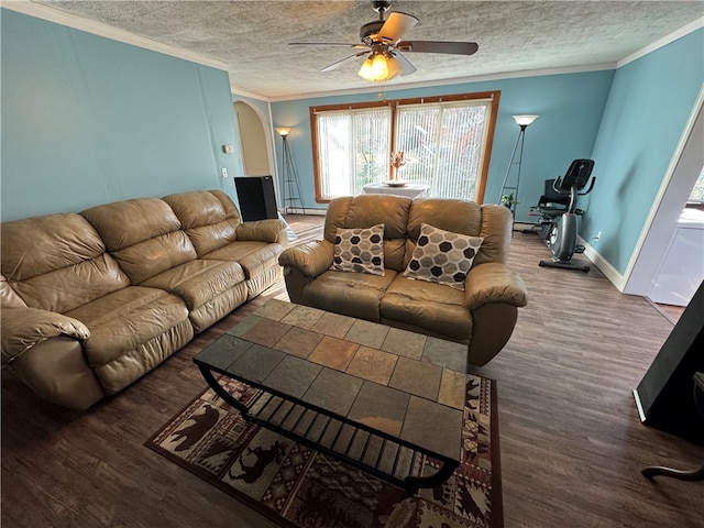 living room featuring crown molding, dark hardwood / wood-style flooring, ceiling fan, and a textured ceiling