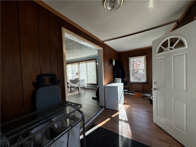 entrance foyer with wooden walls, dark hardwood / wood-style flooring, and a baseboard heating unit