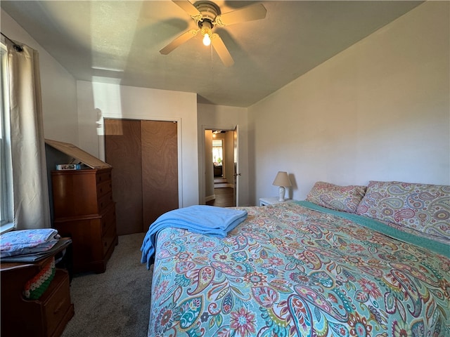 carpeted bedroom with ceiling fan and a closet