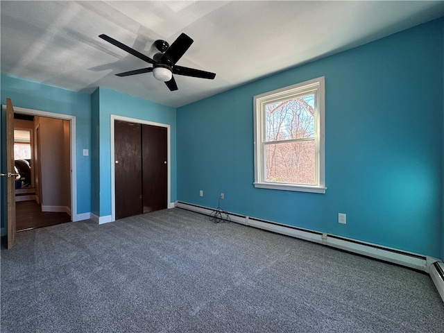 unfurnished bedroom with ceiling fan, a closet, carpet, and a baseboard radiator