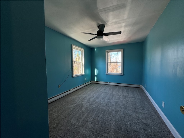 spare room with a textured ceiling, carpet floors, ceiling fan, and a baseboard heating unit