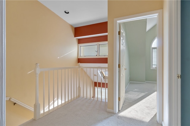 hallway with light colored carpet