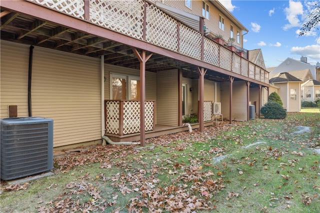 view of property exterior featuring central AC unit and a deck