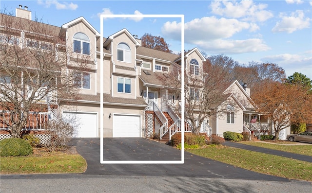 view of front of property featuring a front yard and a garage