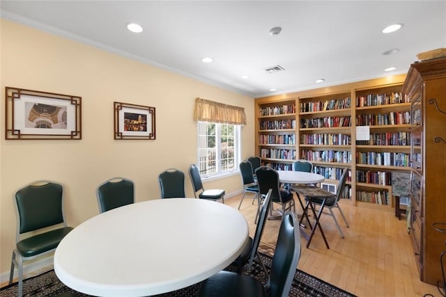 interior space with light hardwood / wood-style floors and ornamental molding