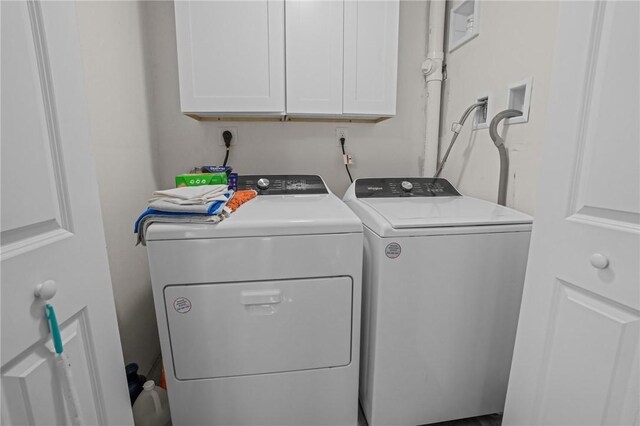 washroom with cabinets and independent washer and dryer