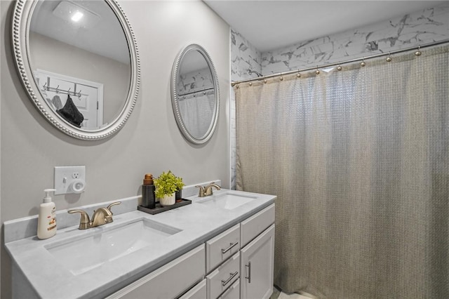 bathroom featuring vanity and curtained shower